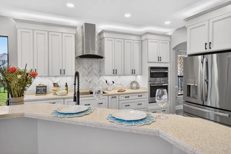 Kitchen island with sink and stainless appliances