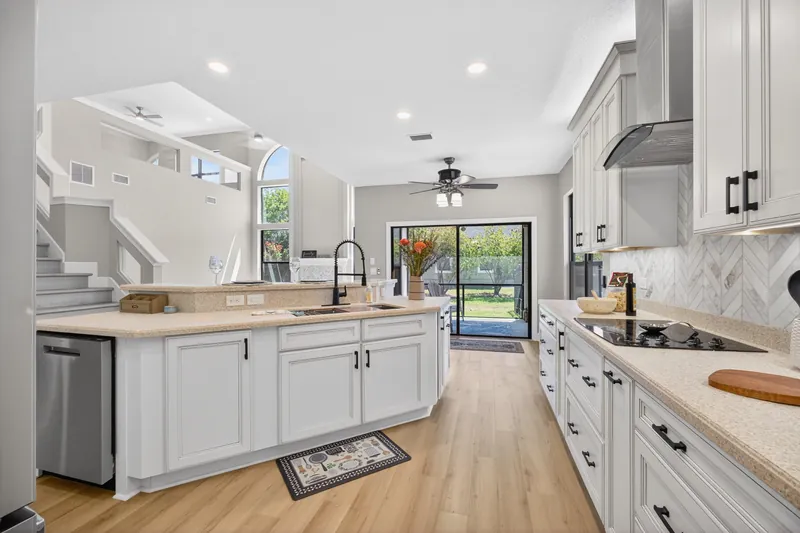 White kitchen with island and range hood