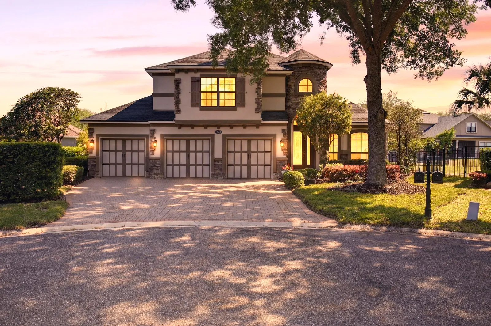 Two-story home at twilight with lit windows